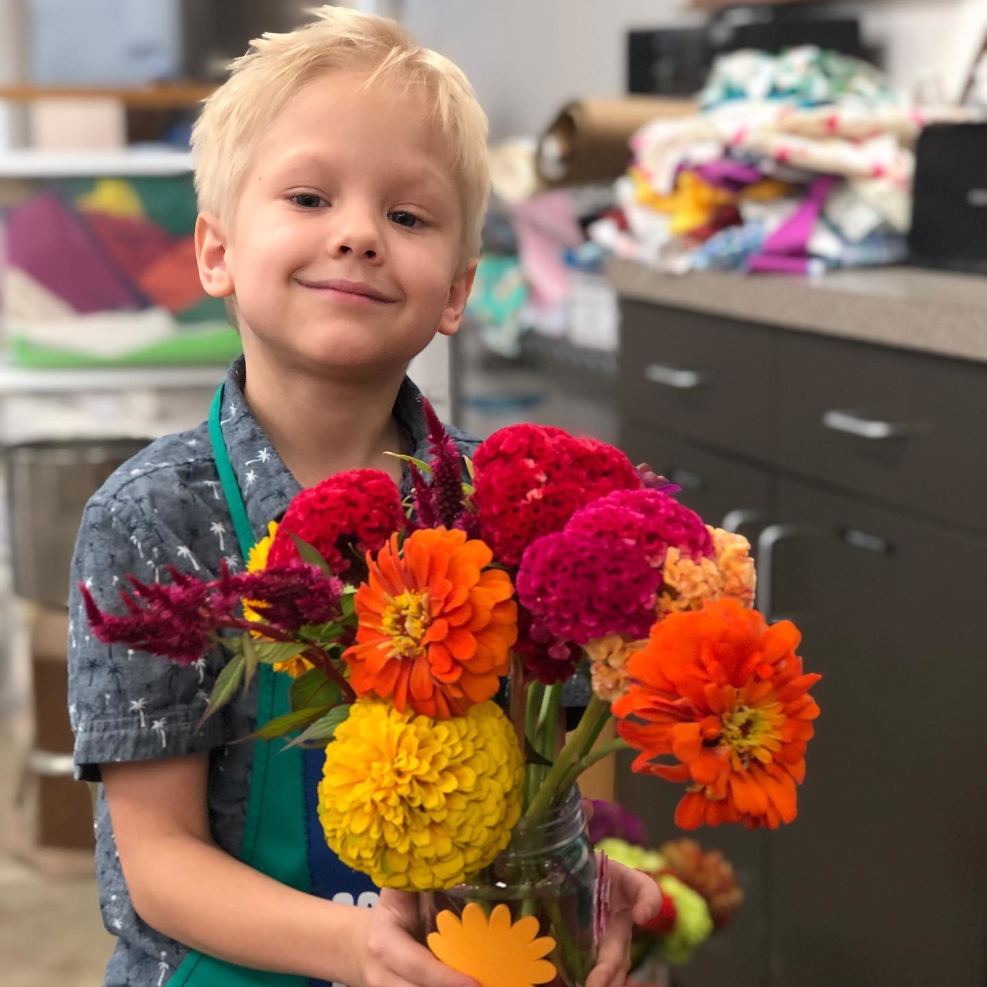 A boy holding a bouquet of flowers