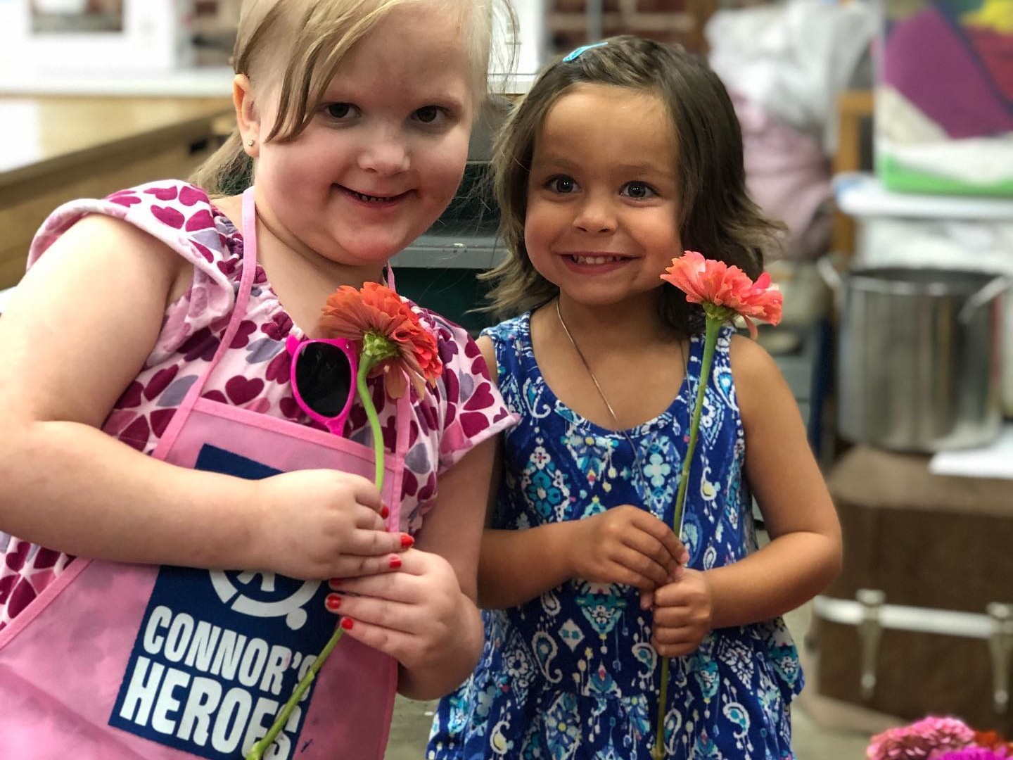 Two girls holding flowers