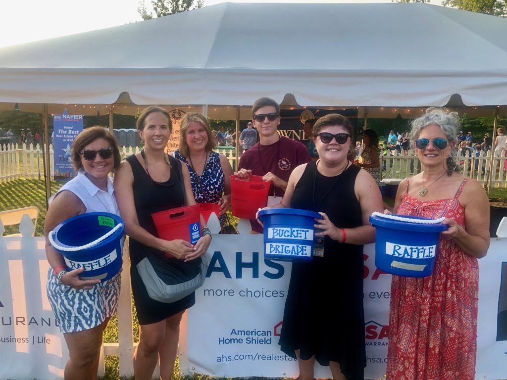 Six volunteers with buckets collecting donations for Connors Heroes