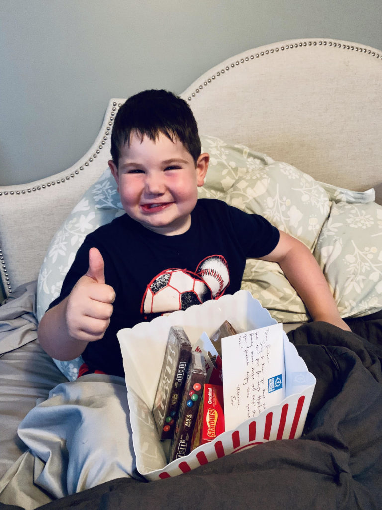 Jaiden gives a thumbs up for the Family Fun Pack he received in the mail from Connor's Heroes
