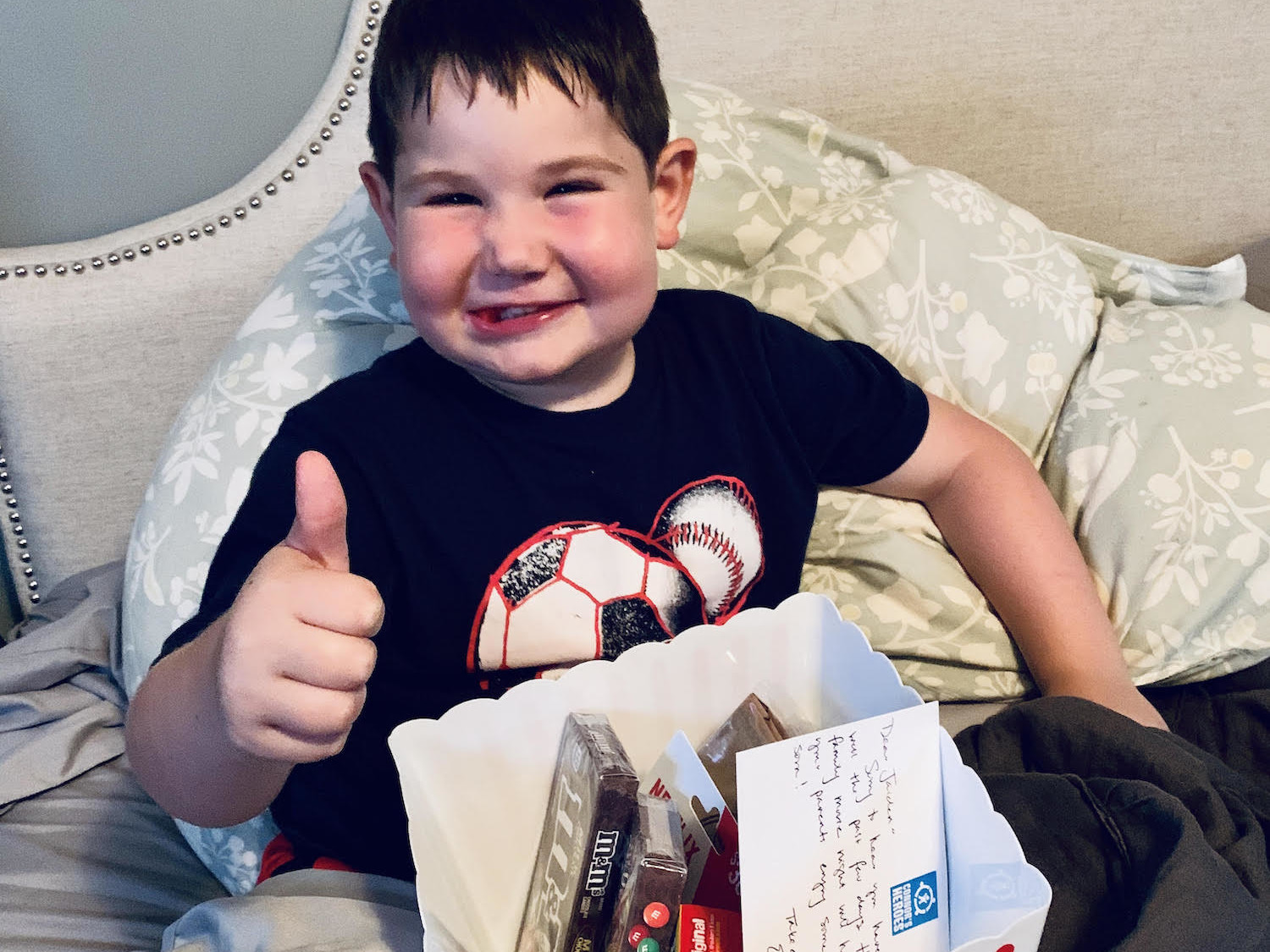 Jaiden gives a thumbs up for the Family Fun Pack he received in the mail from Connor's Heroes