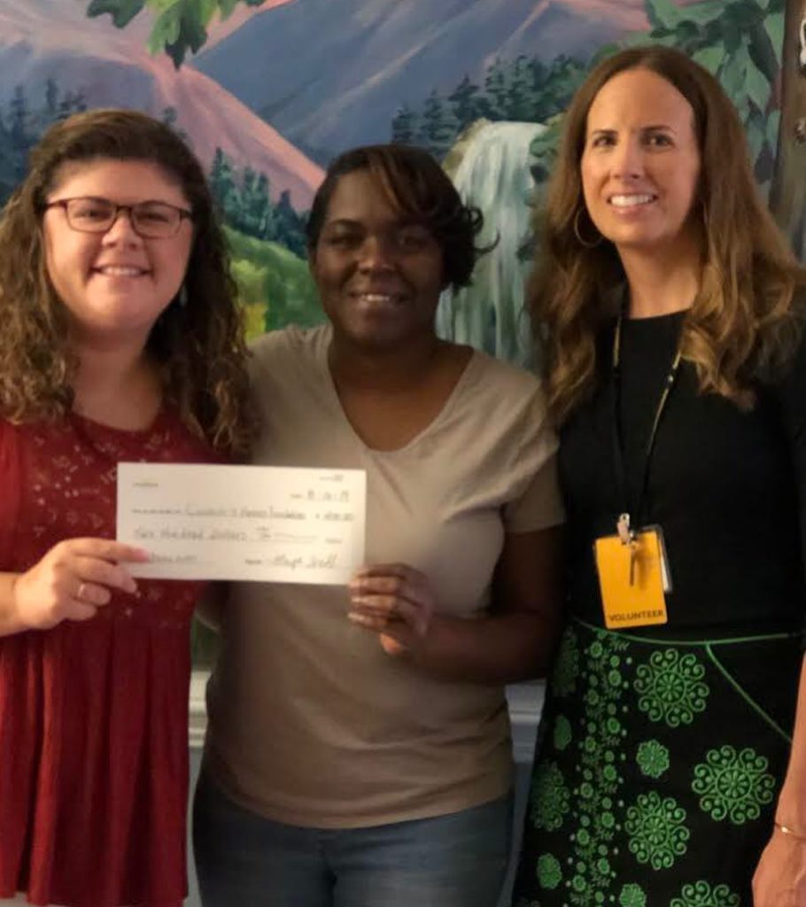 Celia and Erin receive a check from Maya's family