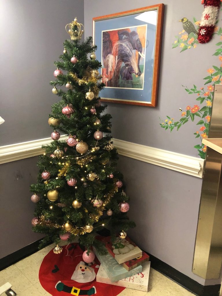 Christmas tree with pink decorations in a child's hospital room
