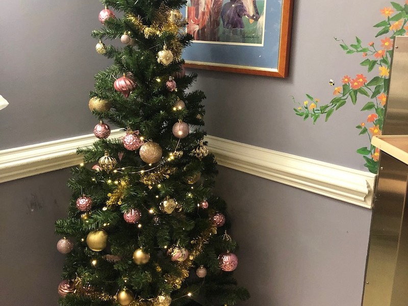 Christmas tree with pink decorations in a child's hospital room