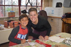 Boy with a volunteer who helped at the Heroes Art Session