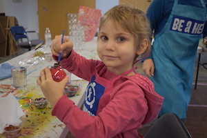 Girl making an ornament at the Heroes Art Session