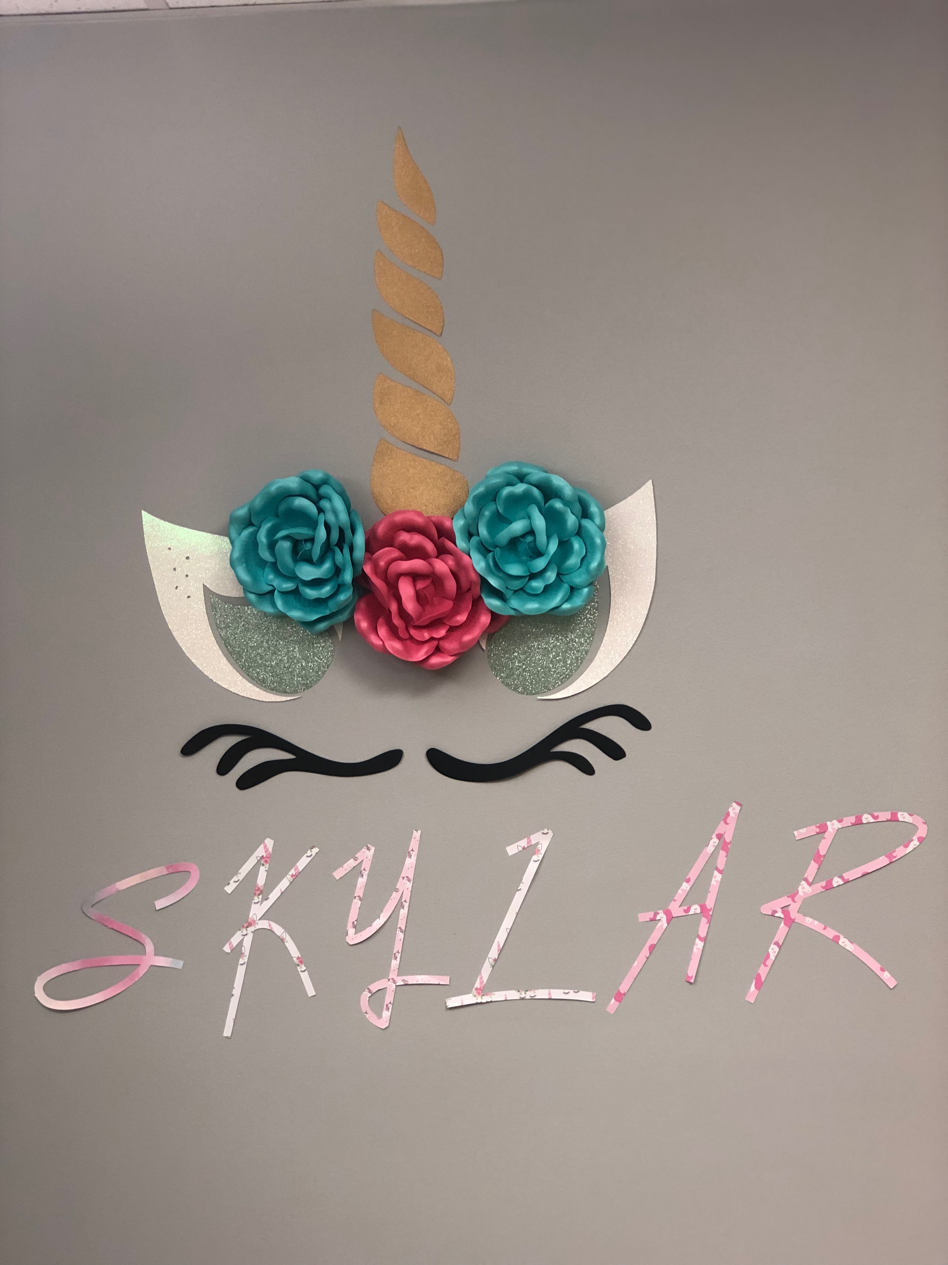 The name Skylar underneath an unicorn mask