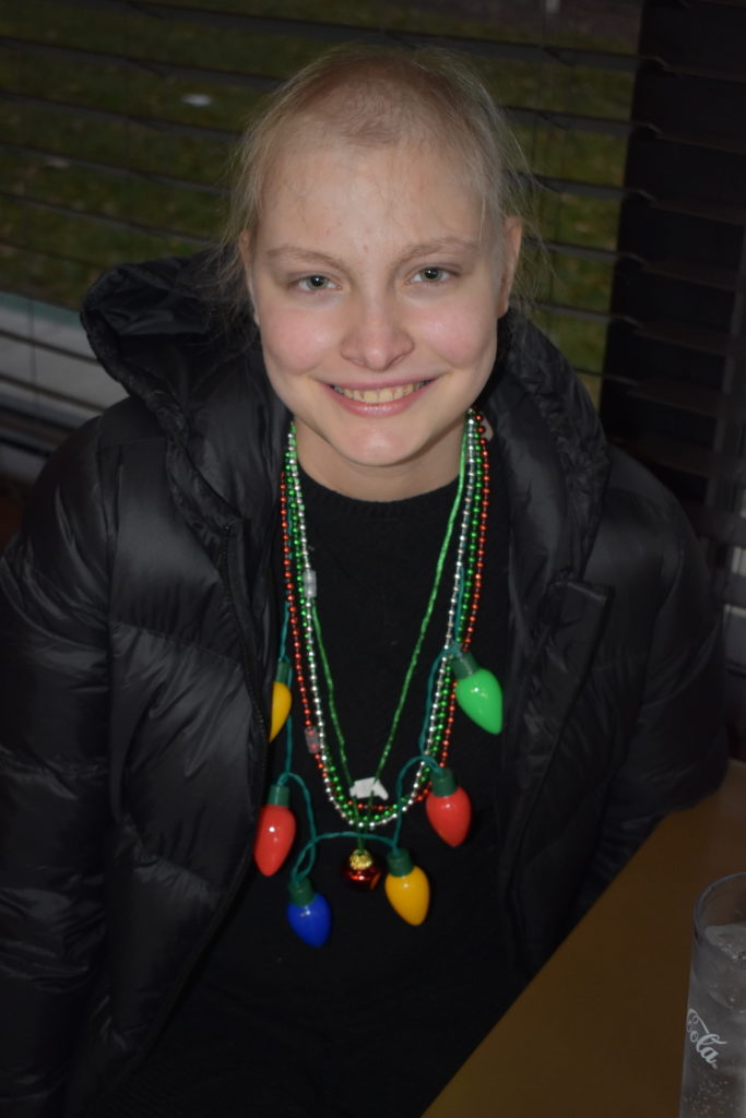 Teen wearing holiday light necklace