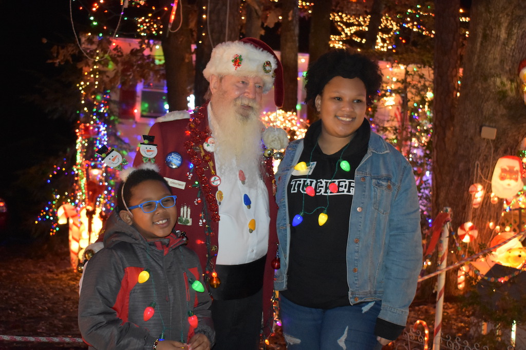Brother and sister standing with Santa