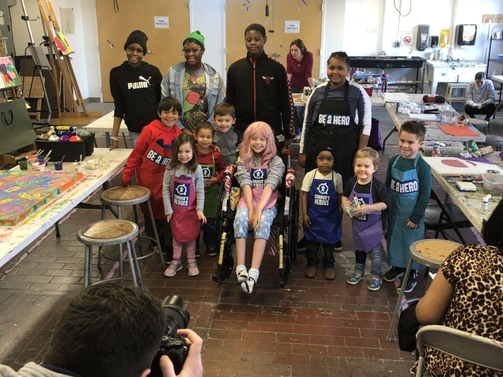 Photographer taking photo of a group of children and teens