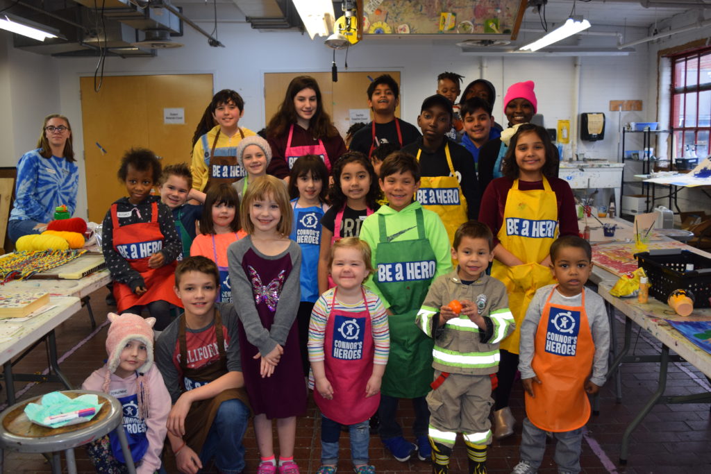 22 children stand together in an art studio for the Connors Heroes art sessions