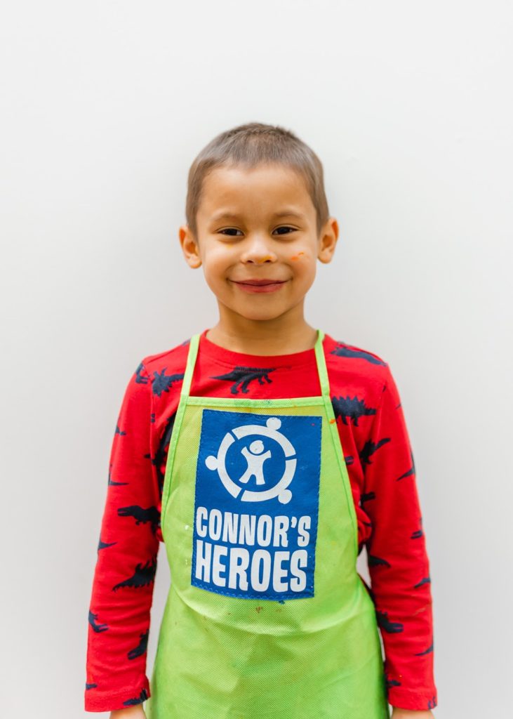 Javi wearing an apron with the Connors Heroes logo