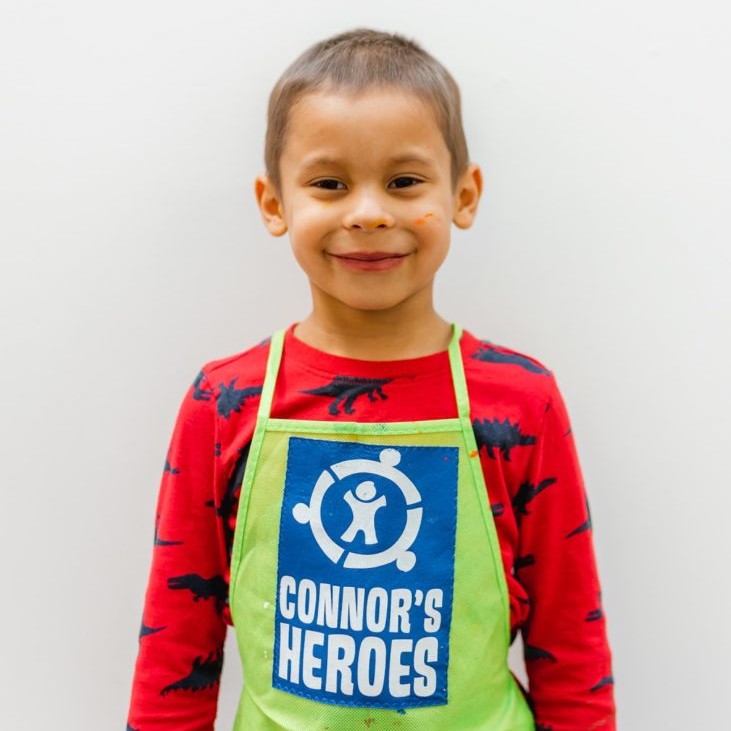 Javi wearing an apron with the Connors Heroes logo