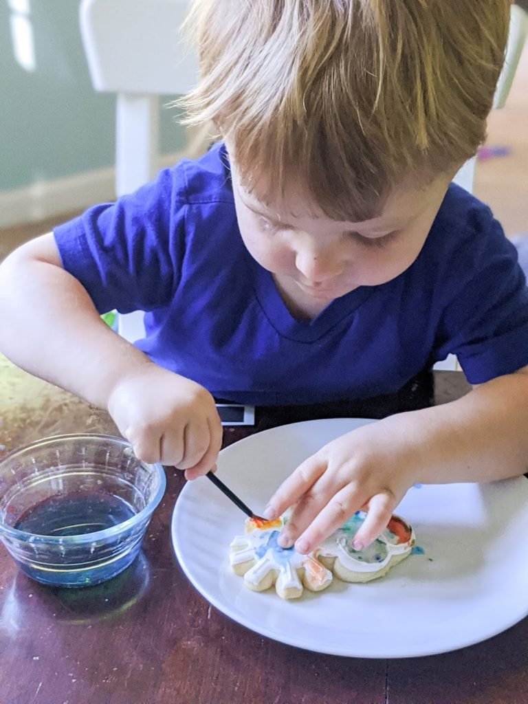 Toddler decorating a cookie