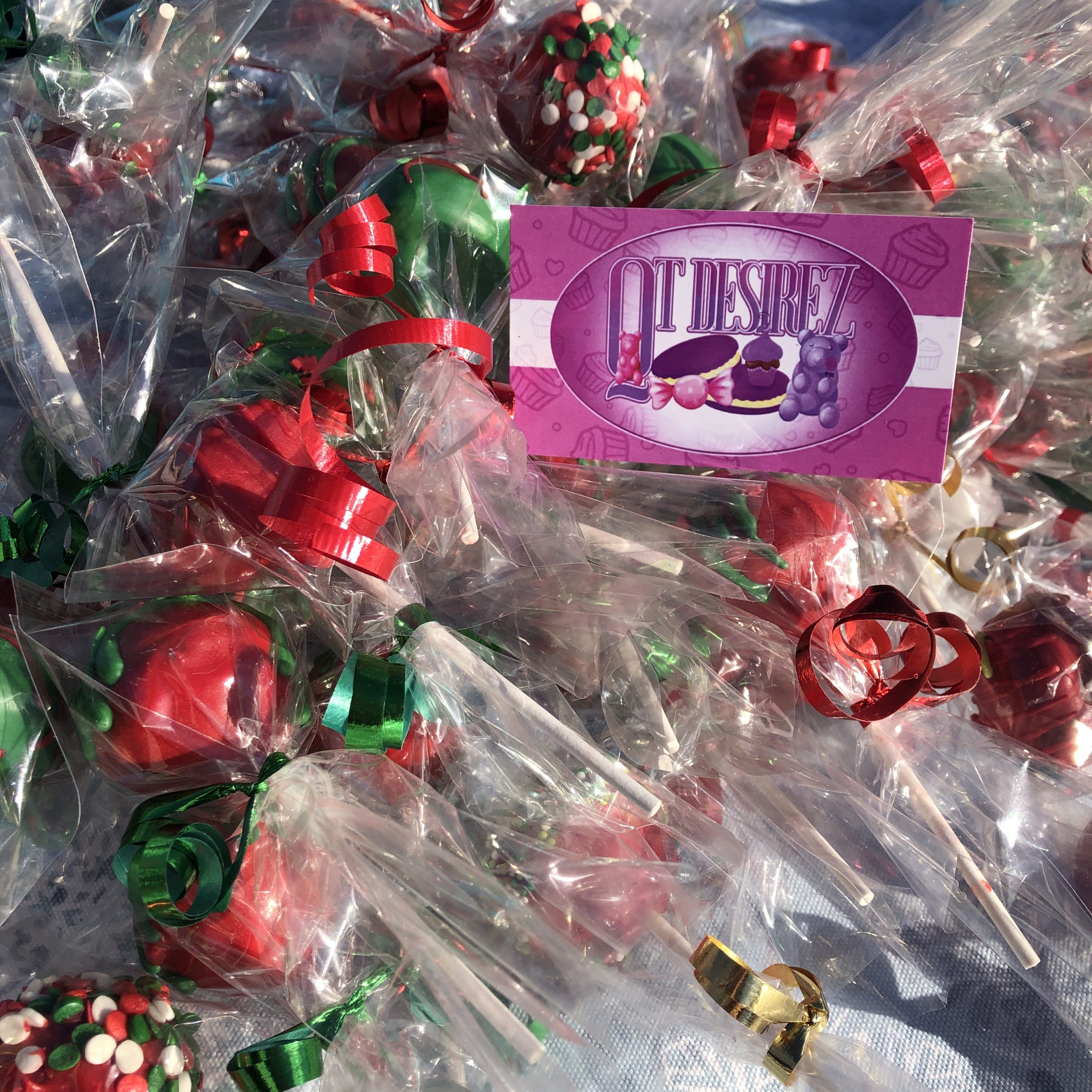 A pile of cake pops wrapped in plastic and with ribbon