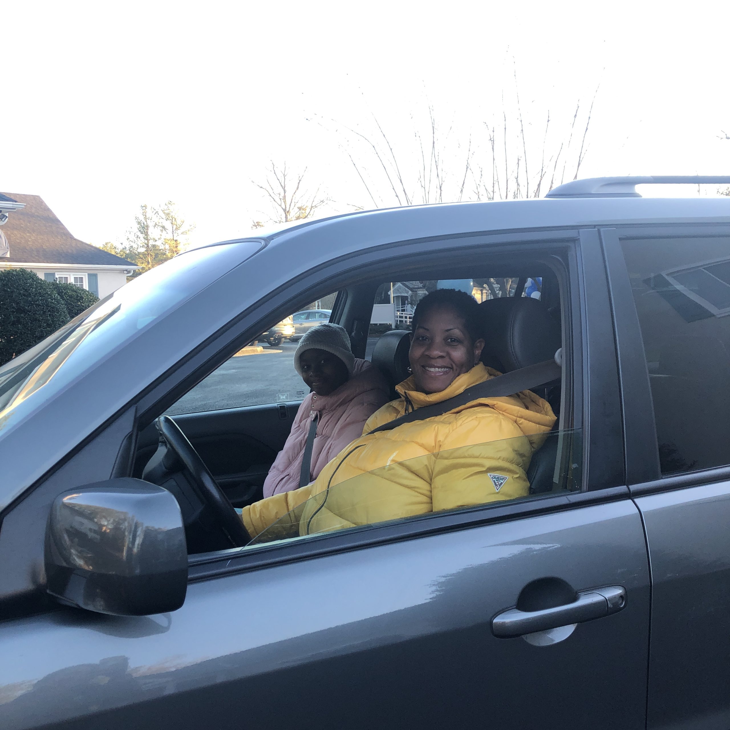 A woman and her daughter sitting in a car