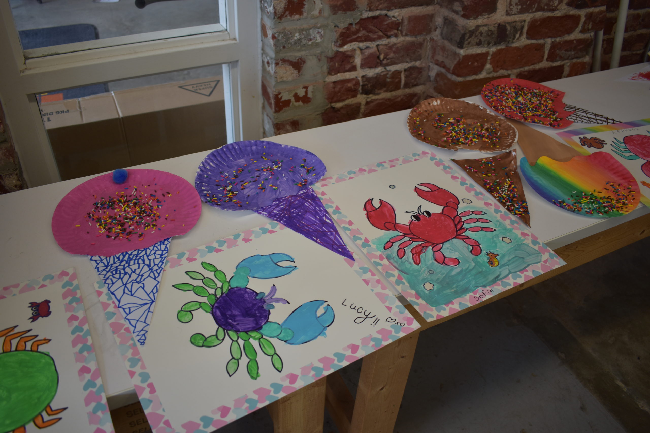 A table with pictures painted by children