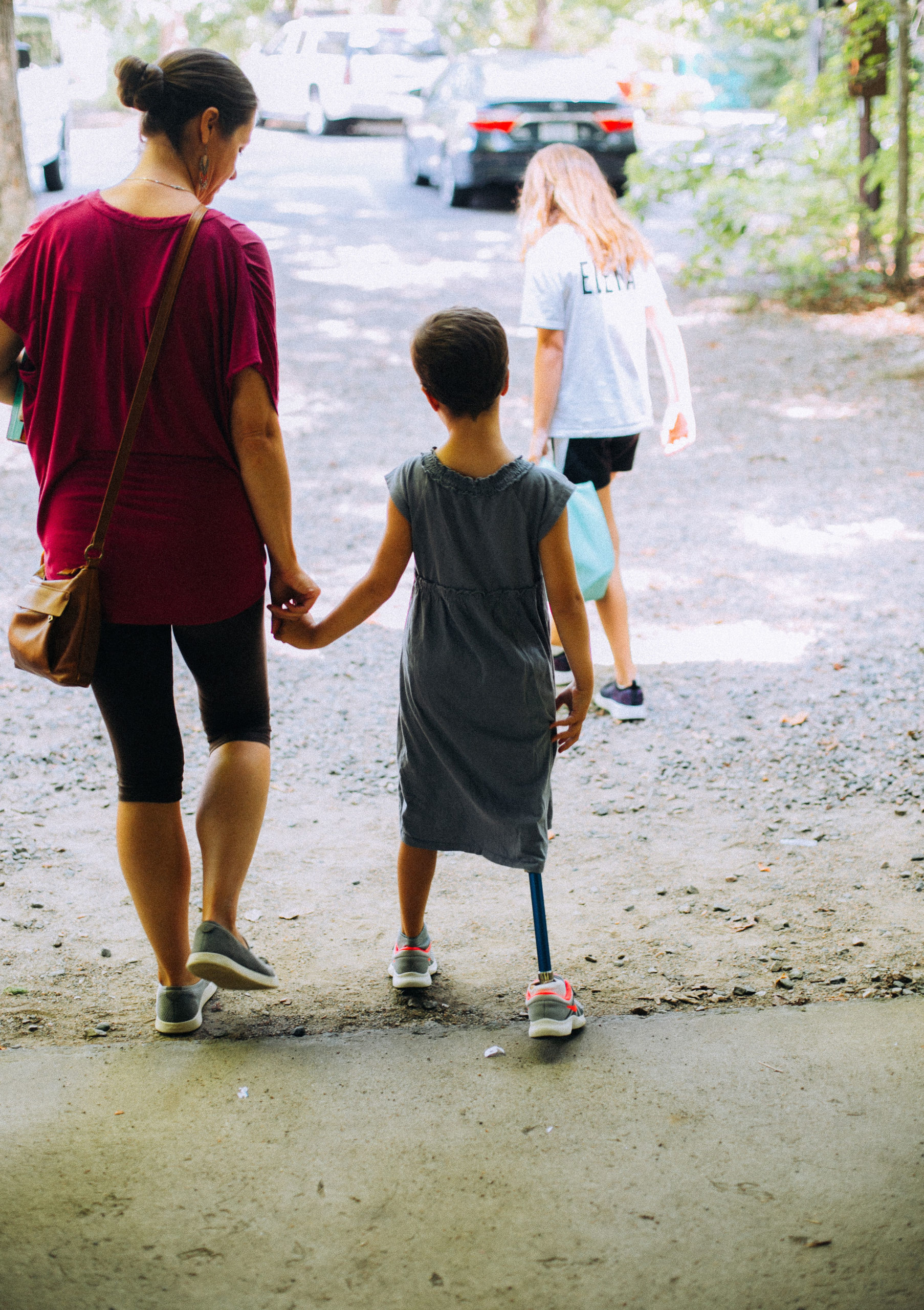 Image a child holding hands with her mom