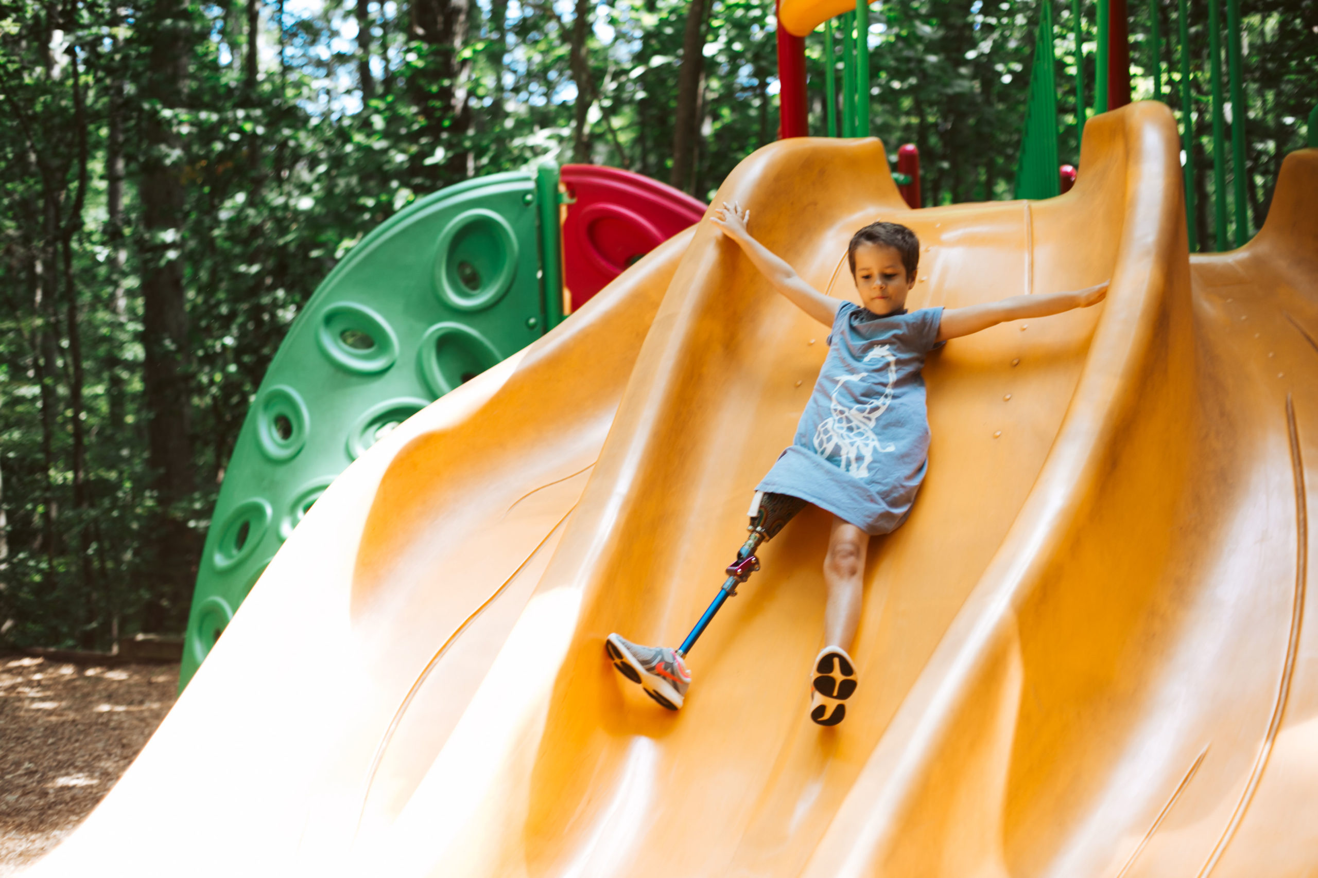 Image photo of child climbing a slide