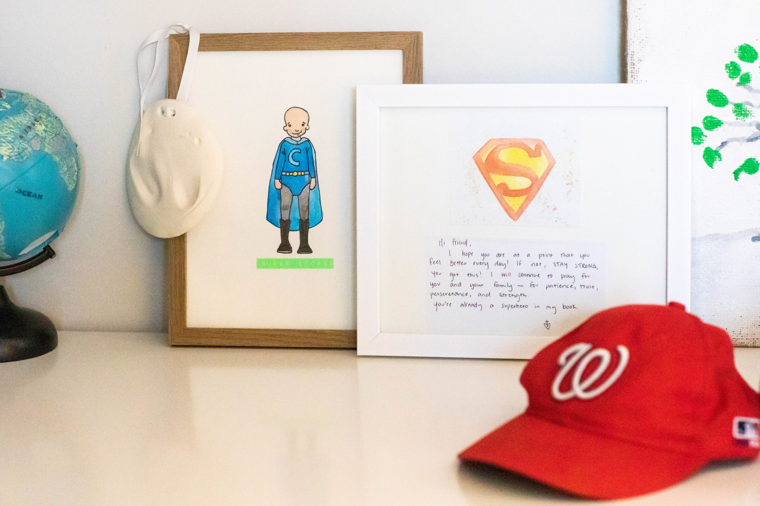 Image a red baseball cap a drawing of superman