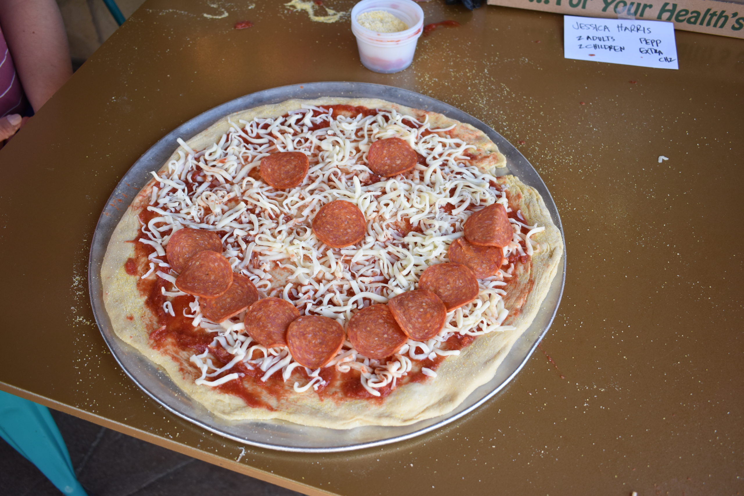 Image a pizza with eyes, nose and mouth made out of pepperoni