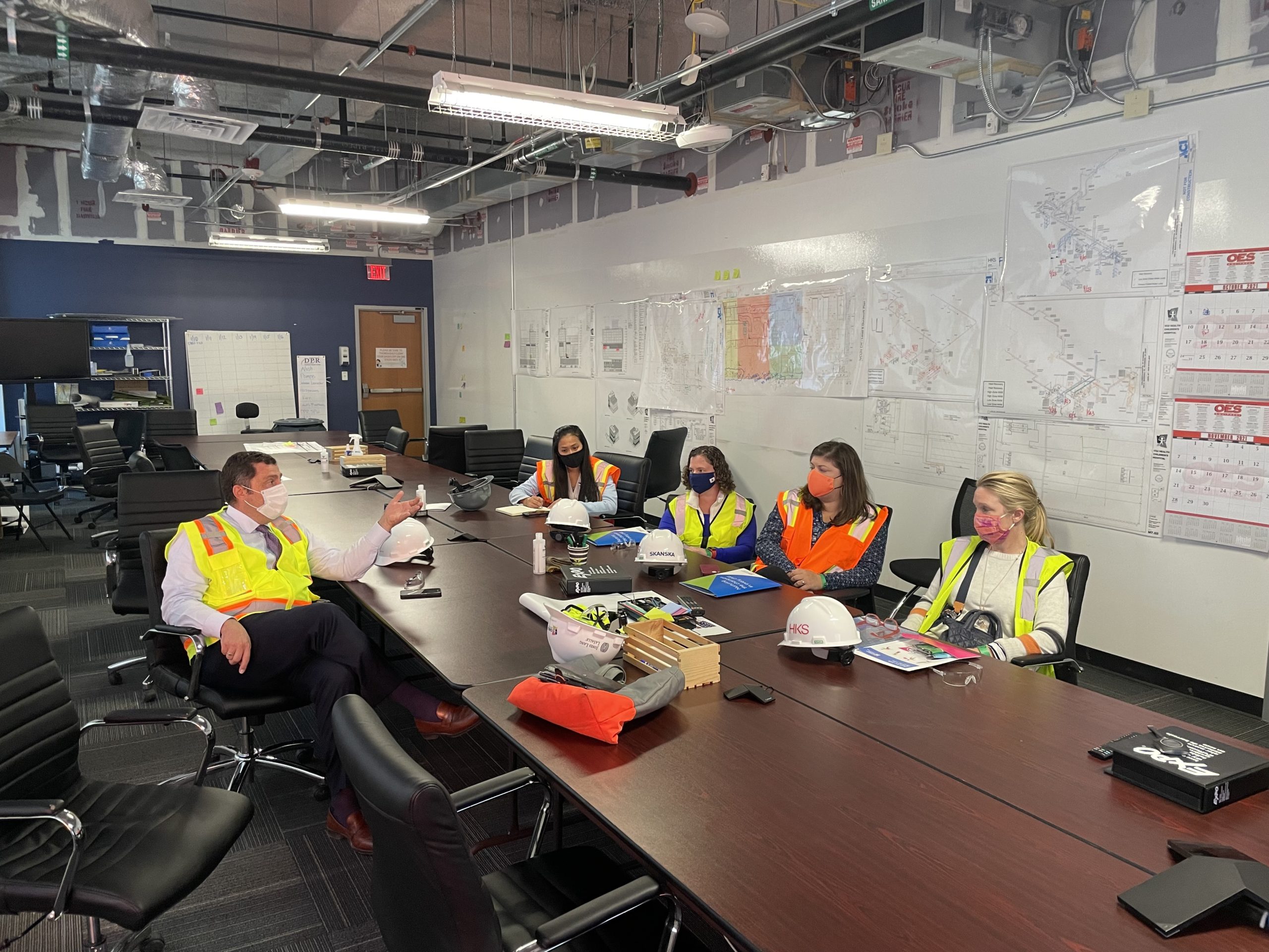 Group of people sitting at a desk at the construction site