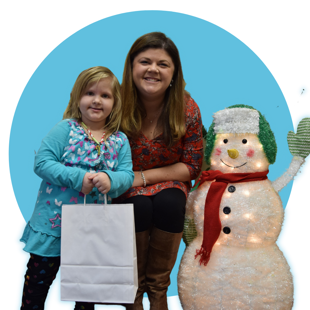an adult and a child standing next to a snowman holiday decoration