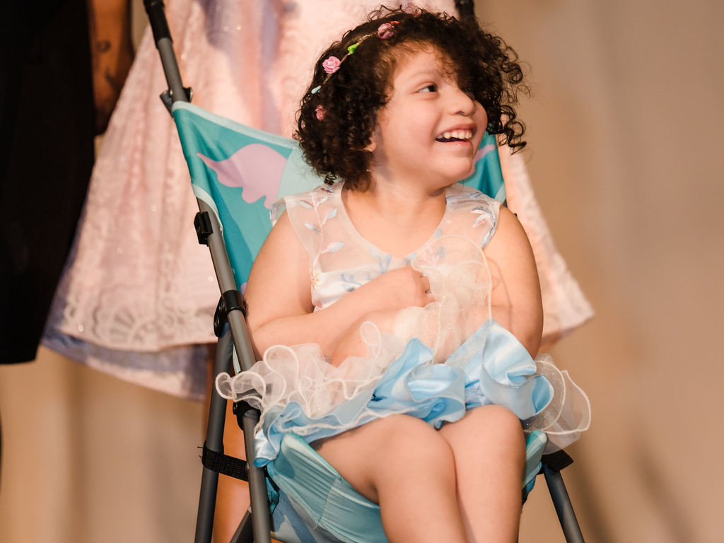 A girl in a stroller is smiling