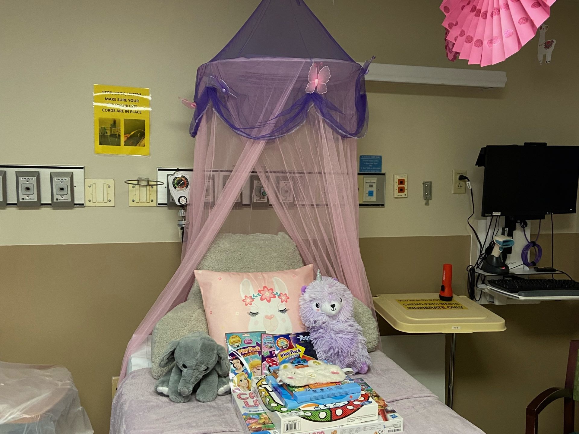 a hospital bed decorated with pillows