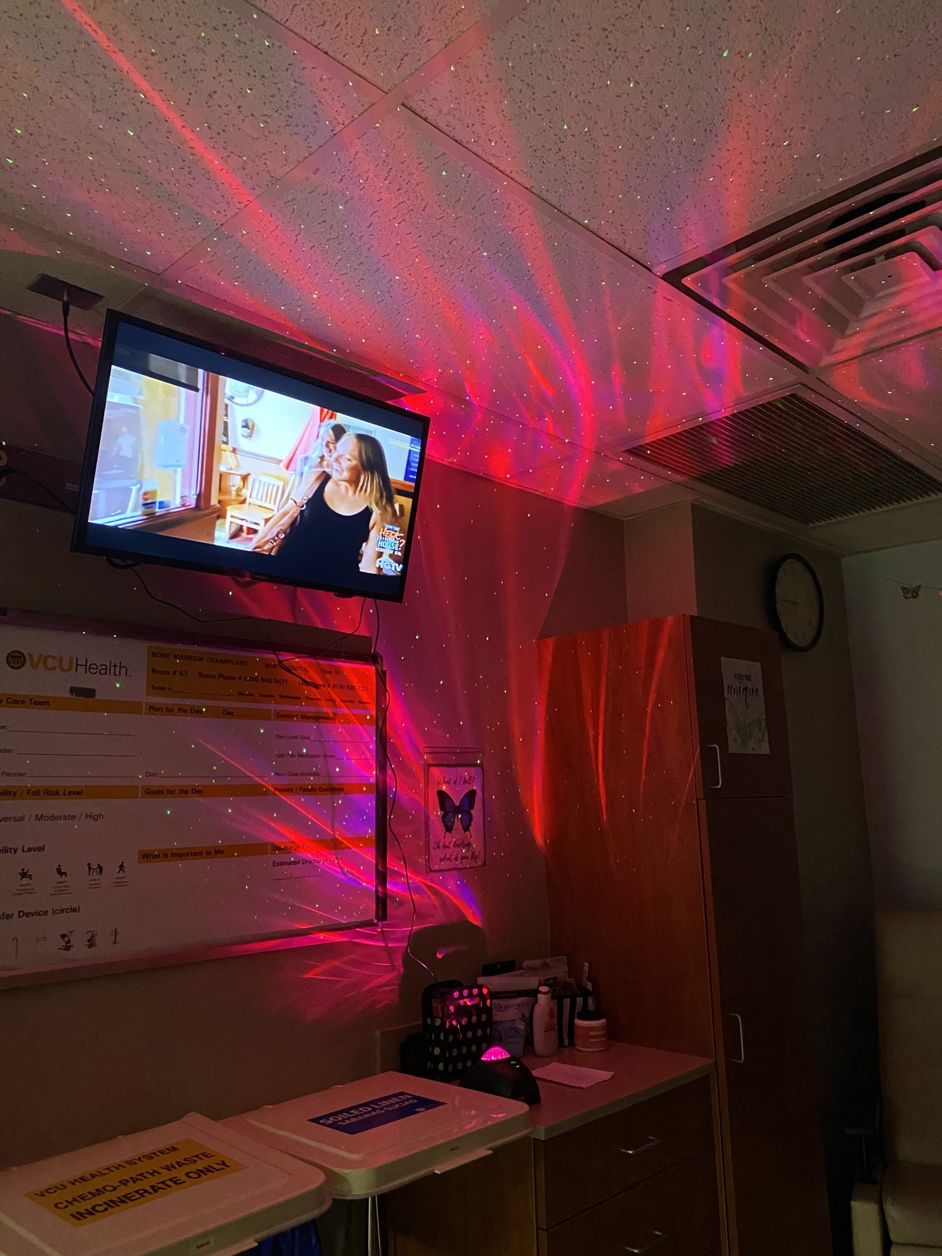A pink light shines on the wall of a hospital