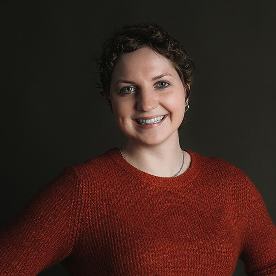 Teen wearing a red sweater and smiling