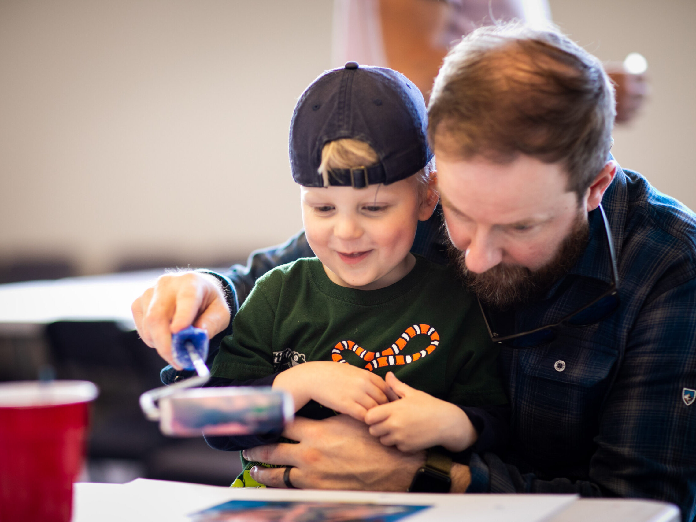 James and his dad use a roller to paint