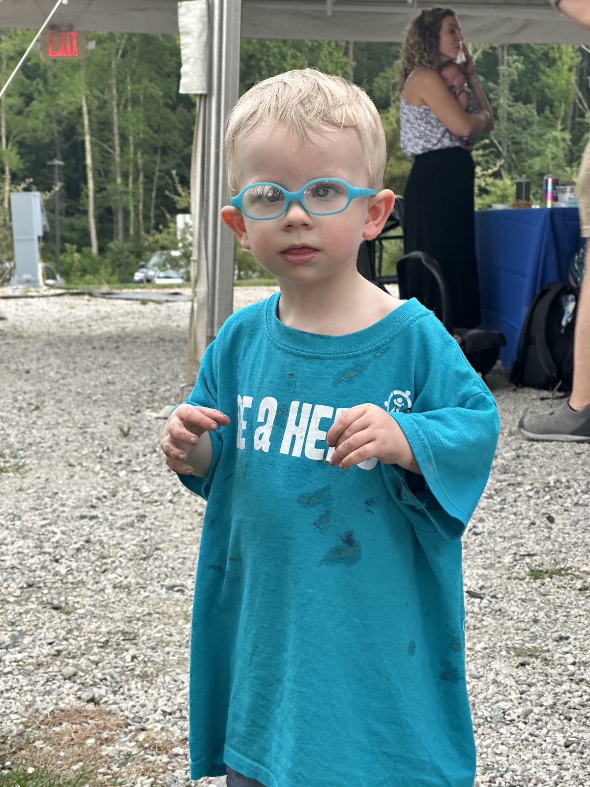 A boy wearing a blue Be A Hero shirt