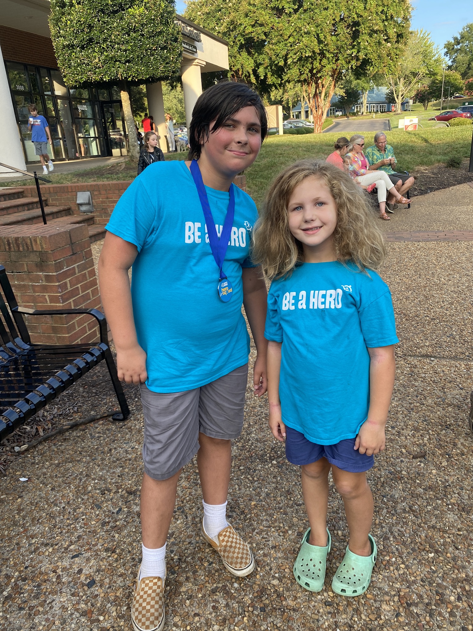 Two children wearing Be A Hero t shirts