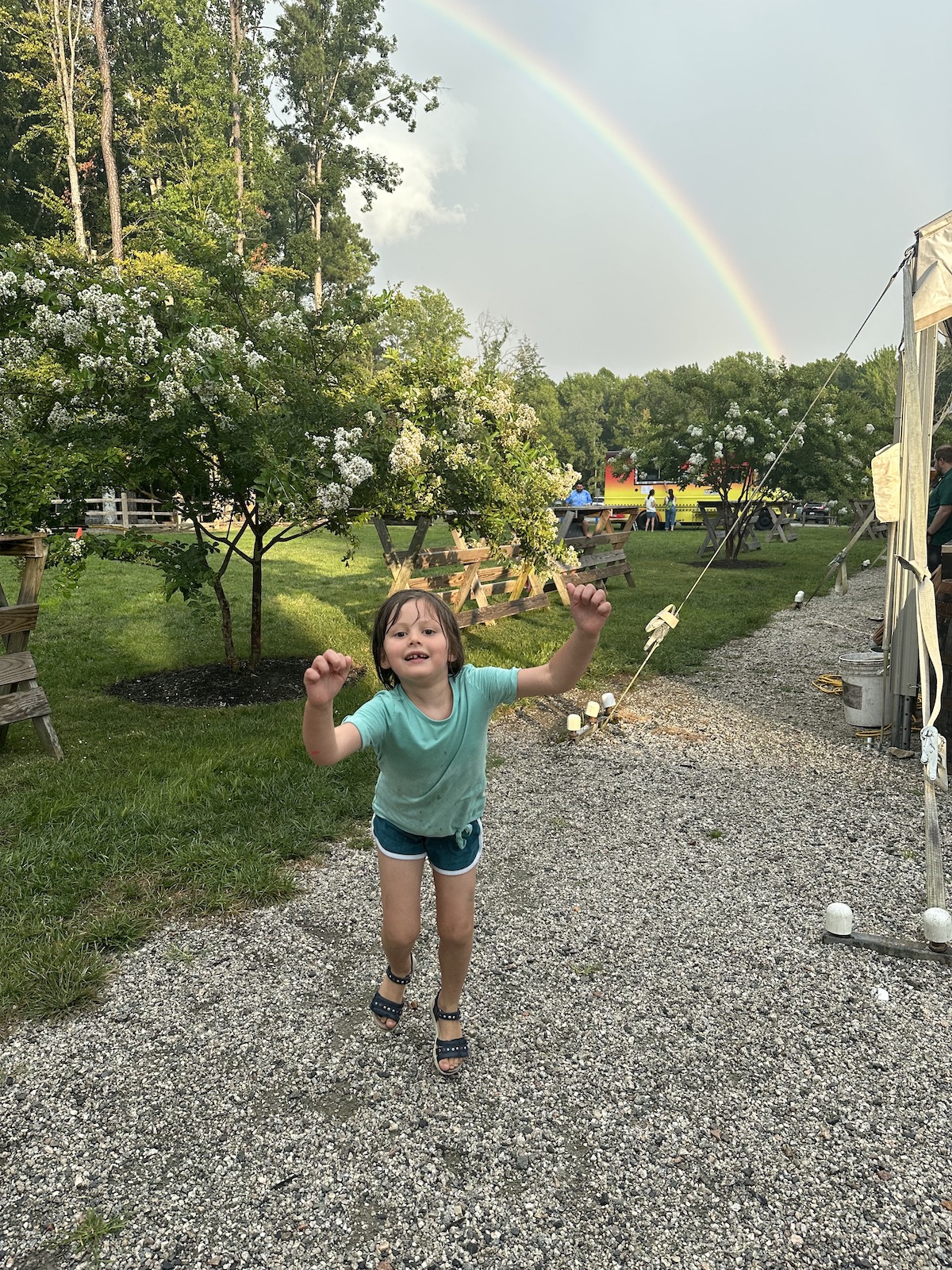 Girl standing in front of a rainbow