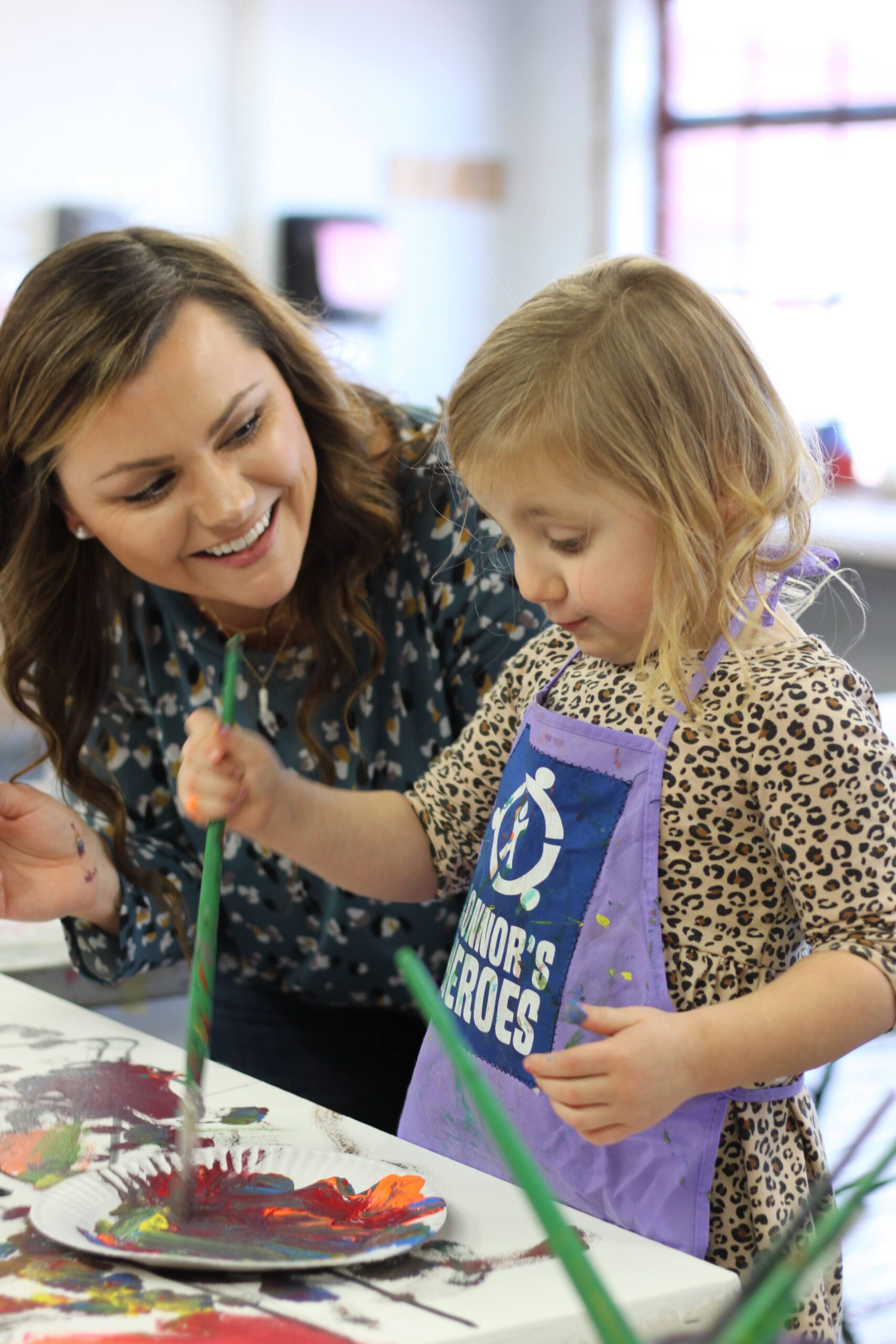 Mom watches her daughter paint