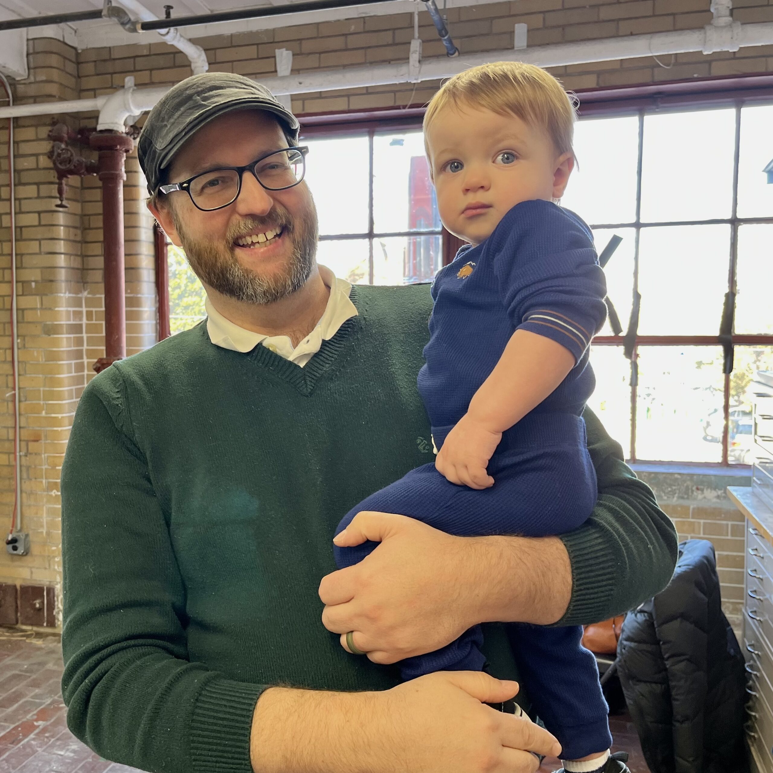 A dad is holding his son at Connor's Heroes Art Session