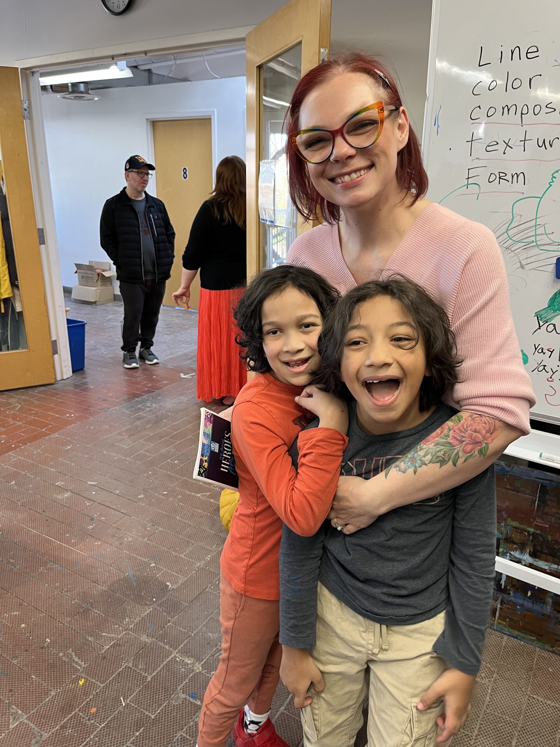 A mom hugs her two sons at Connor's Heroes Art Session