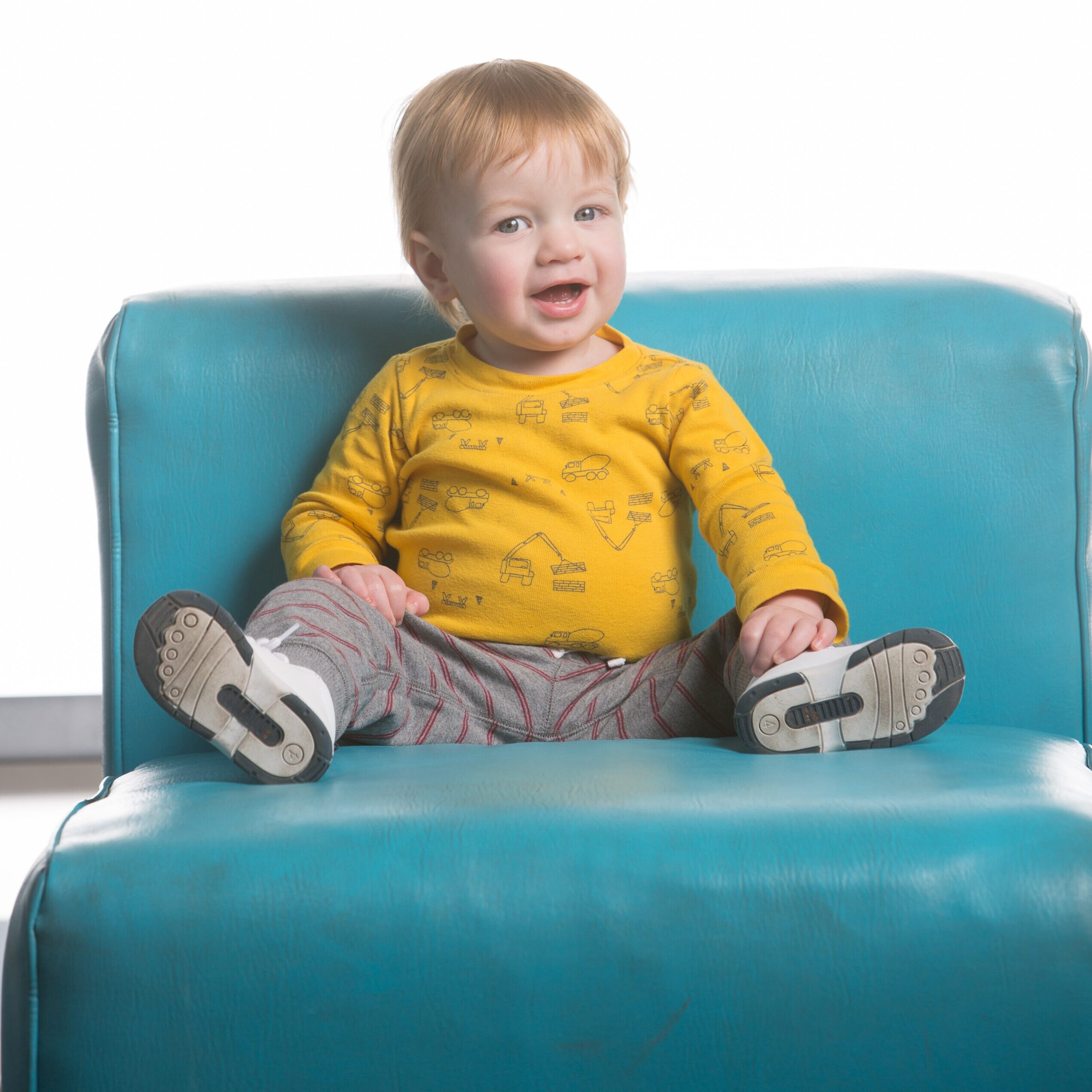 Harri sitting on a blue couch