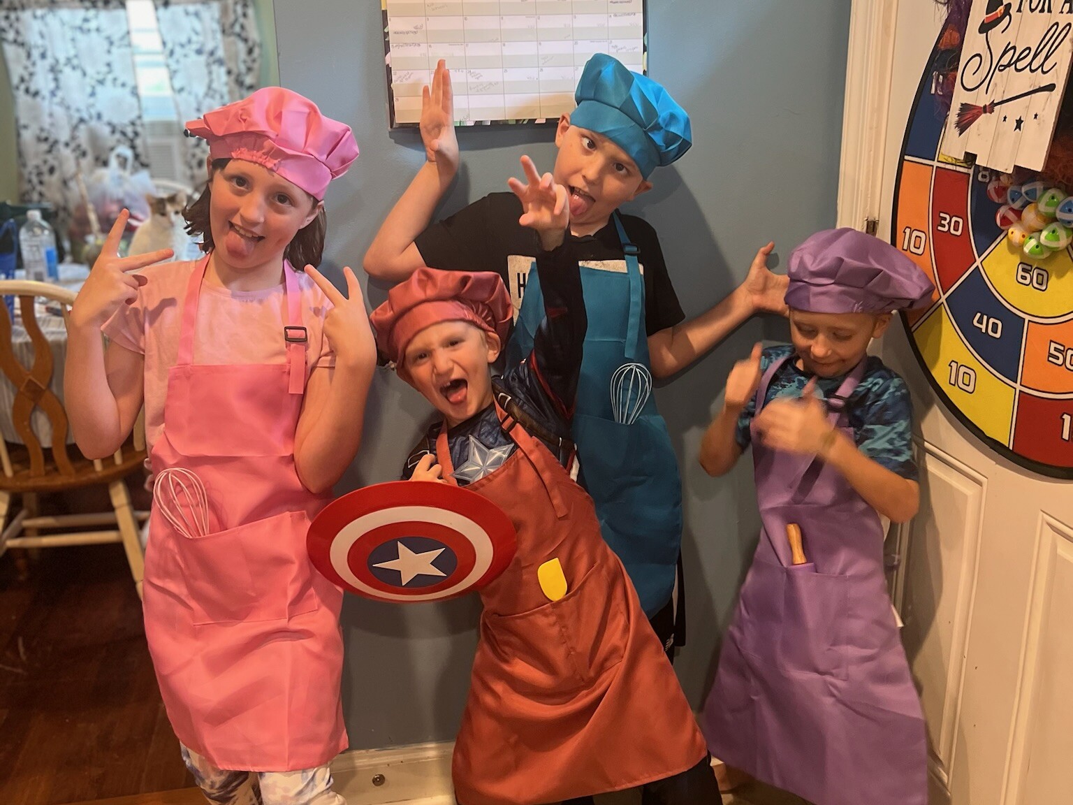 Four children making goofy faces