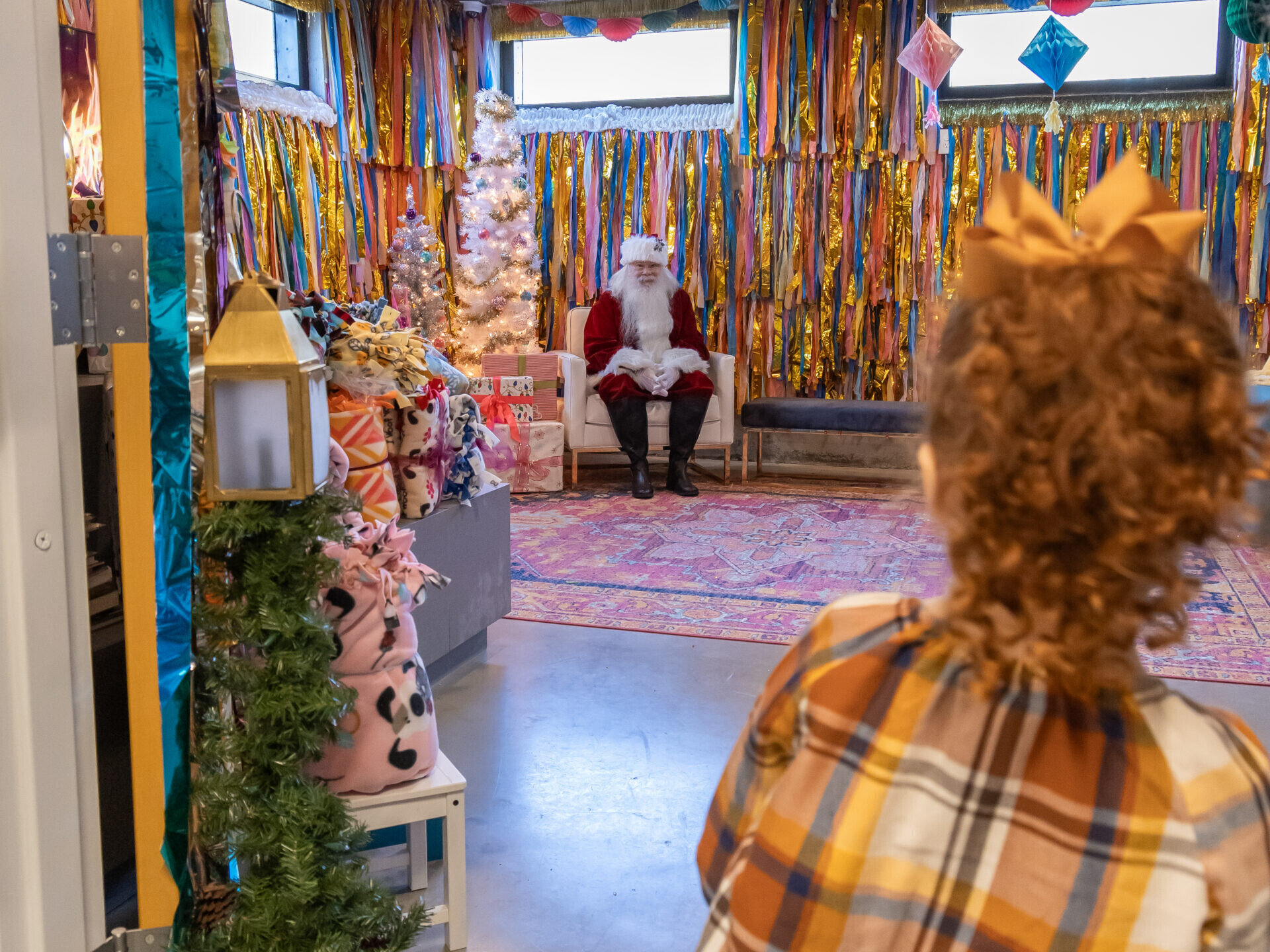 Girl peeks at Santa