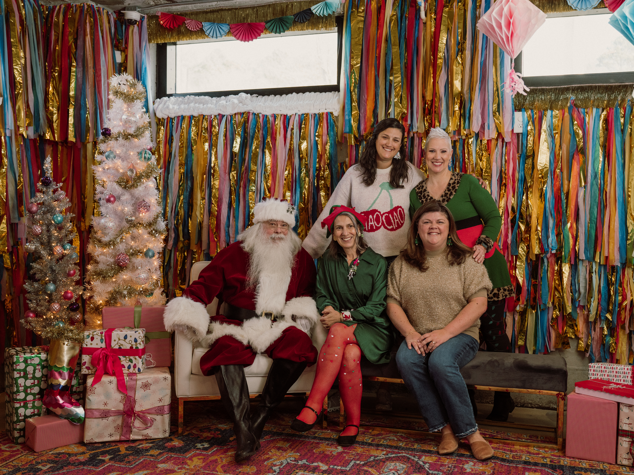 Connors Heroes staff sit next to Santa