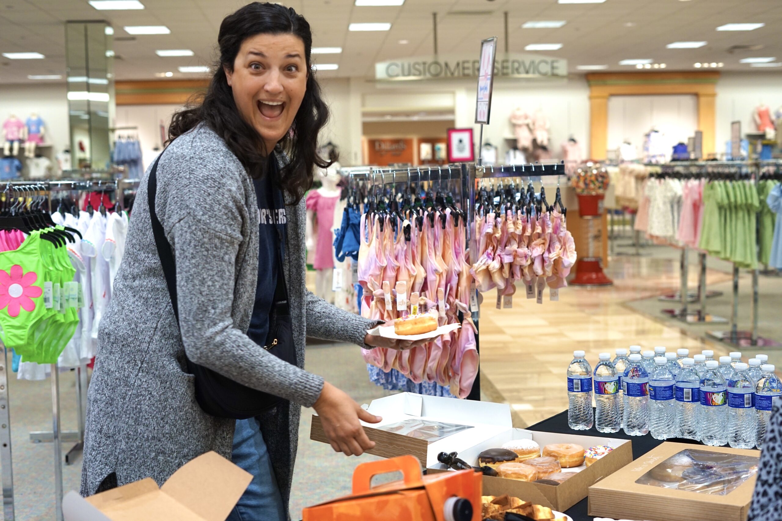 Jillian serves donuts to families