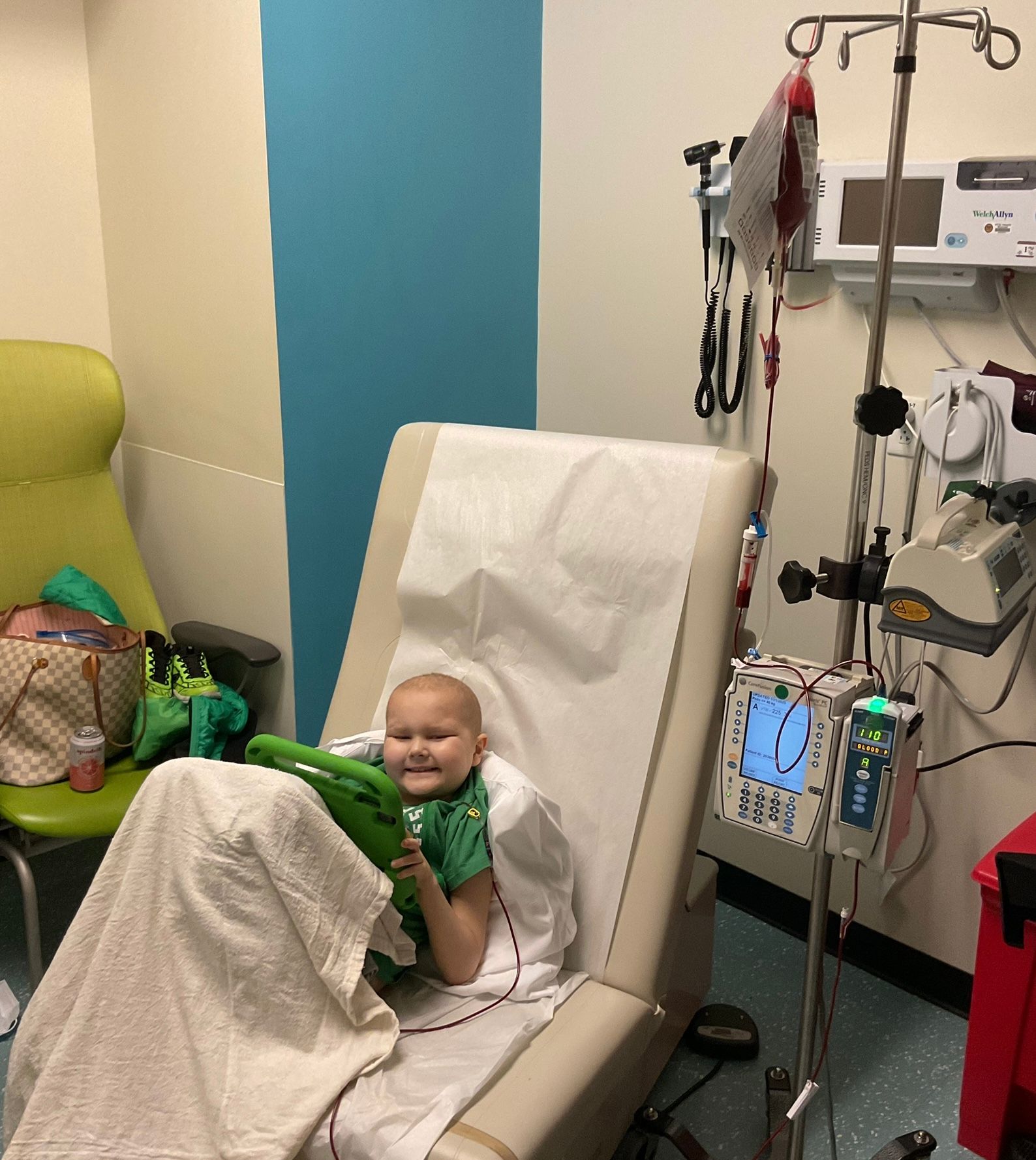 A boy is in the hospital with an ipad