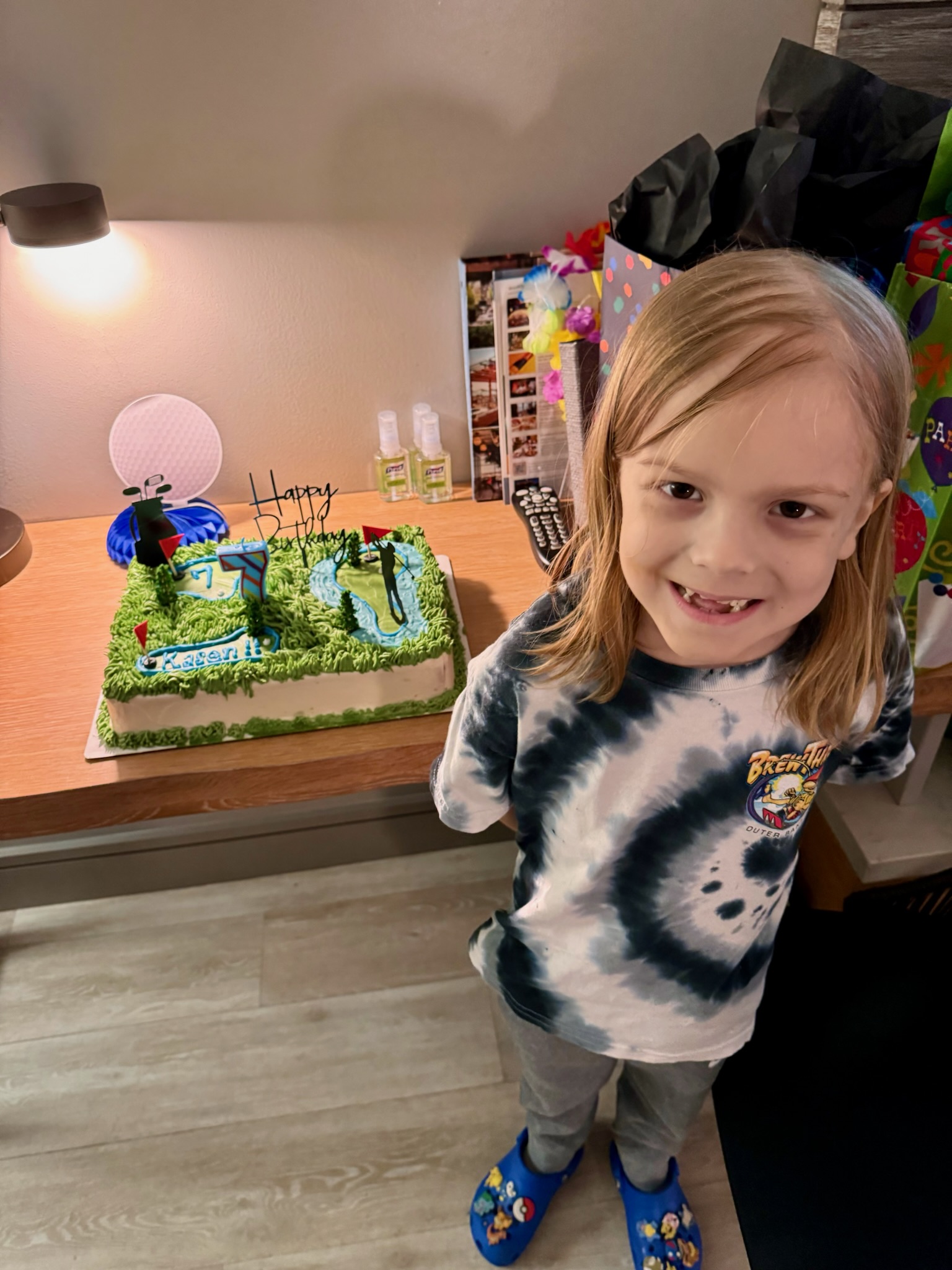 A boy stands next to a cake