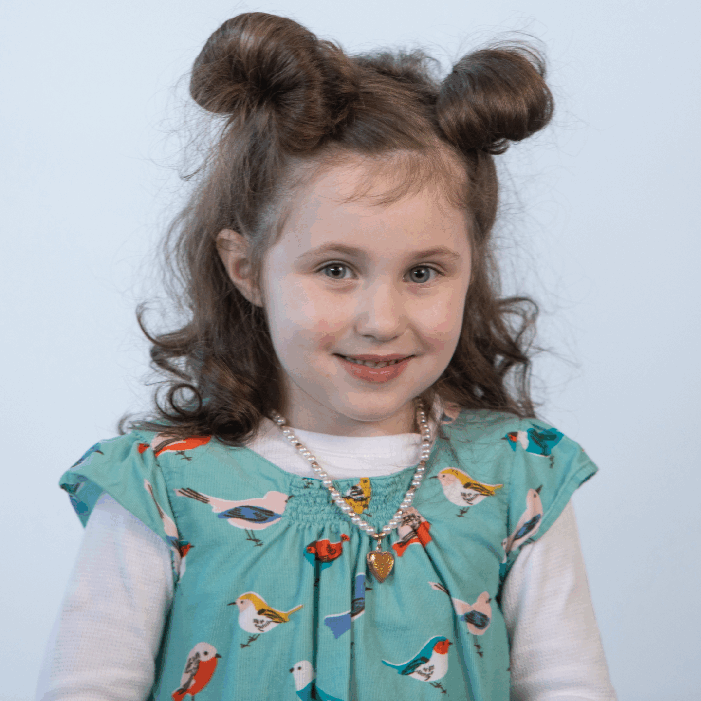 a child with cancer poses for a photo