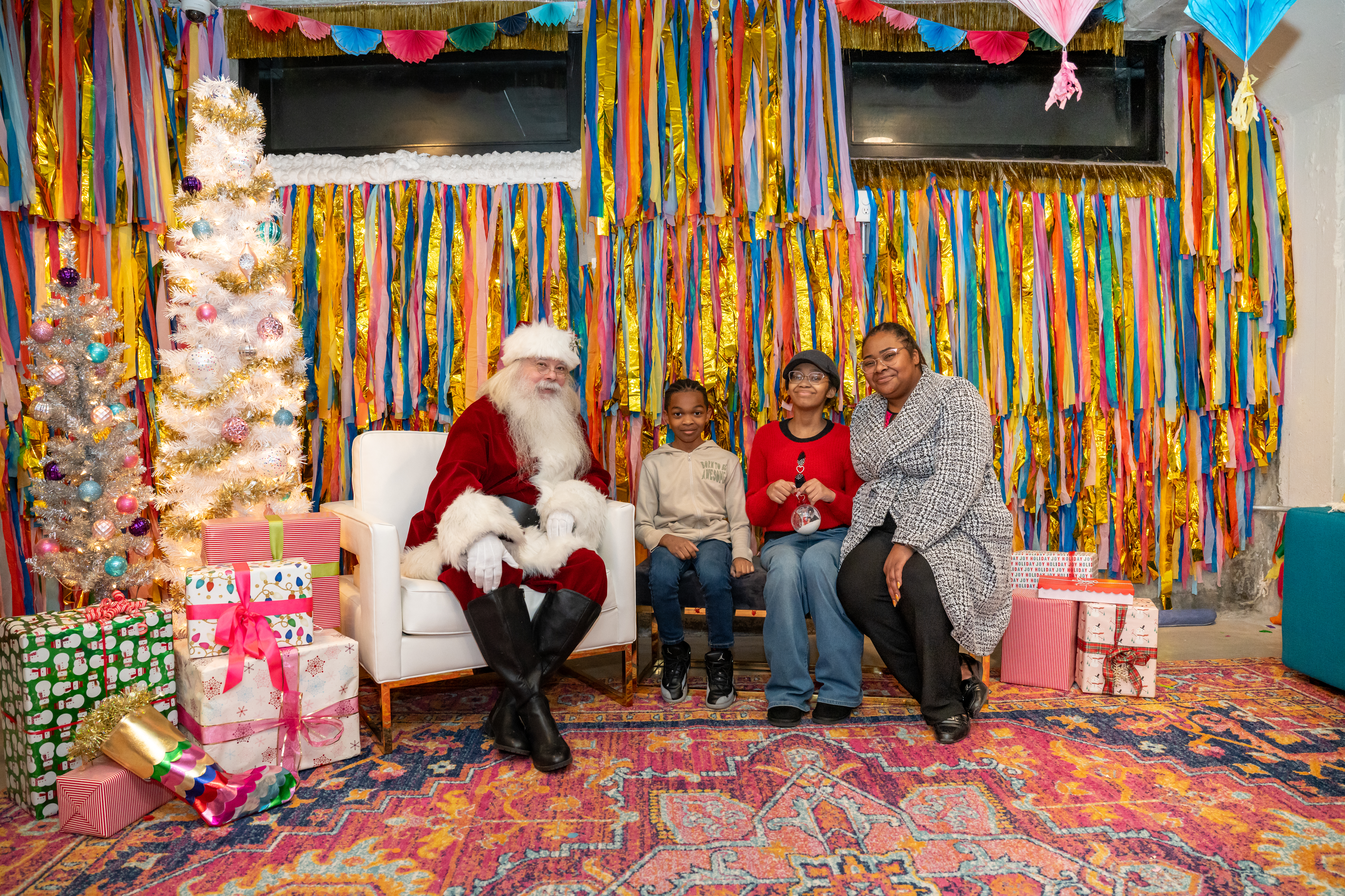 a family sits with santa at a party