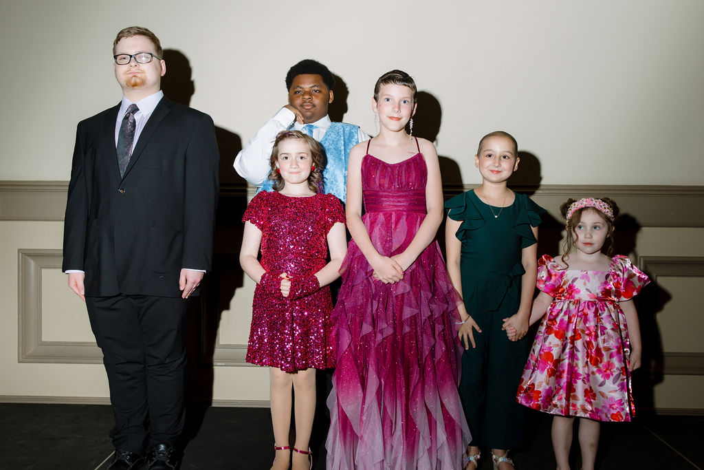 Kids standing on stage for the heroes art ball