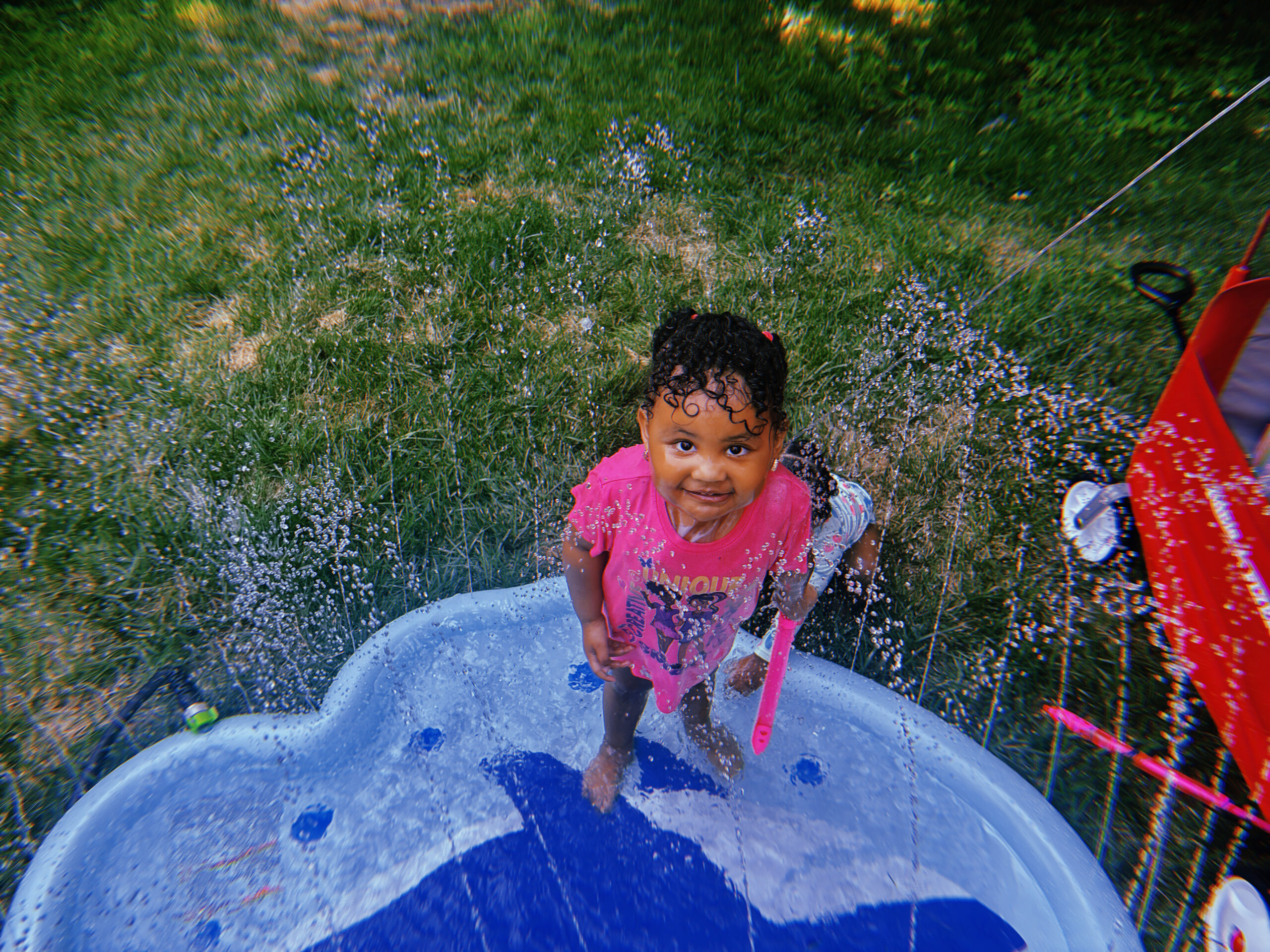 Girl standing in an inflatable pool