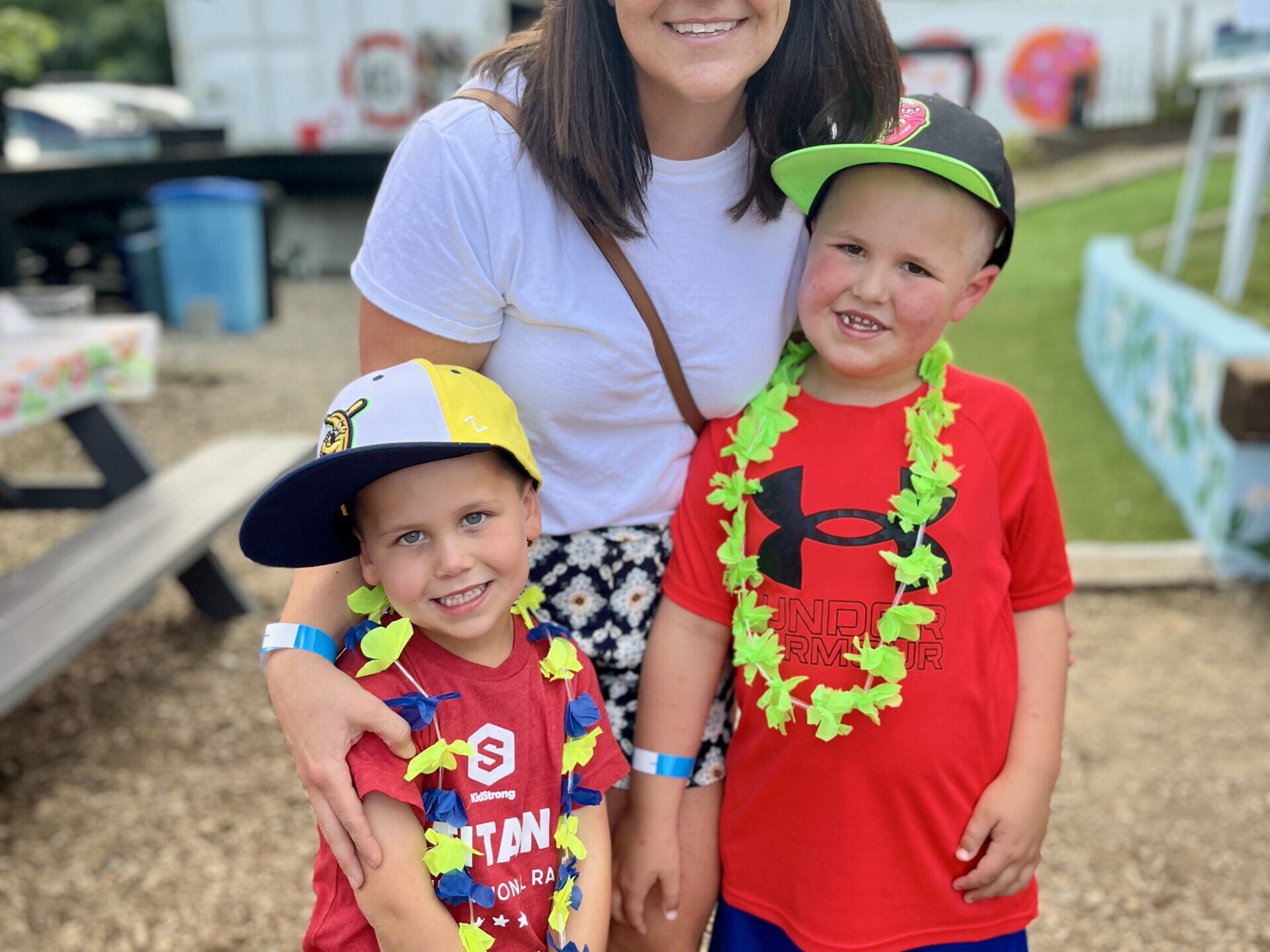Two children with their parent at a luau